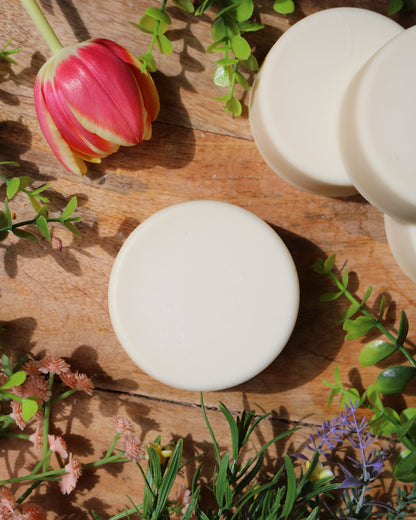 artisan soap bars on a wooden surface with greenery and flowers